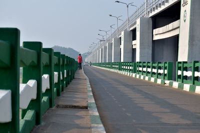 Rear view of man walking on footpath