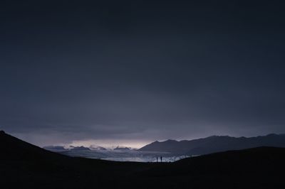 Silhouette of mountain against cloudy sky