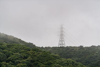 Low angle view of electricity pylon against sky