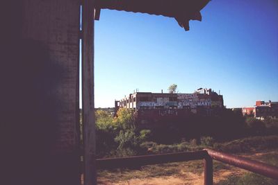 Low angle view of built structure against clear blue sky