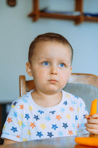 Portrait of cute boy eating food at home