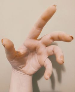 Close-up of person hand over white background