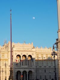 Low angle view of buildings against blue sky