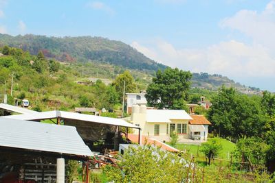 Houses in town against sky