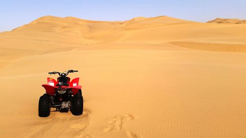 Quadbike parked on desert landscape