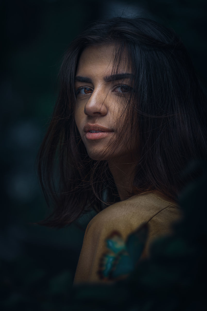 one person, headshot, hair, portrait, long hair, women, black hair, looking, hairstyle, real people, young women, young adult, leisure activity, adult, lifestyles, contemplation, indoors, casual clothing, looking away, beautiful woman