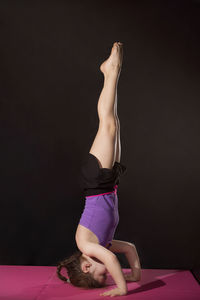 Midsection of woman wearing mask against black background