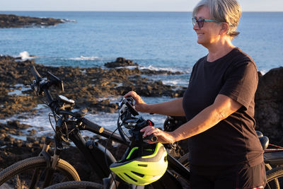 Young woman riding motorcycle on beach