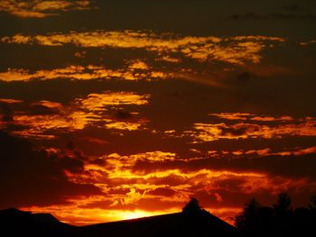 Low angle view of dramatic sky during sunset