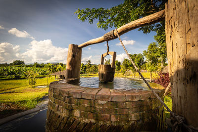 Scenic view of an old well against sky