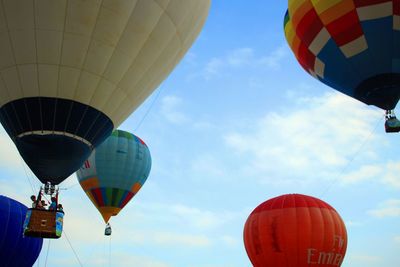 Low angle view of hot air balloons against blue sky