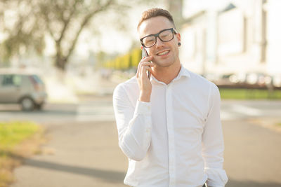 Young man using mobile phone outdoors