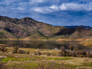Scenic view of lake and mountains against sky