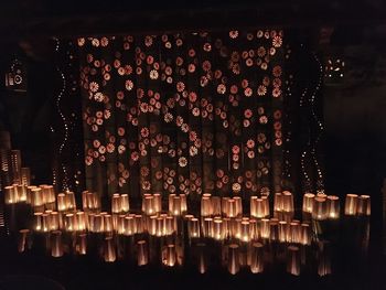 Illuminated lanterns hanging in building at night