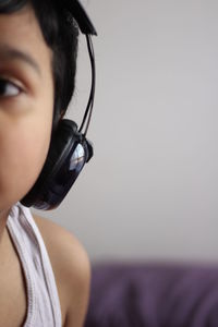 Cropped image of boy listening to music at home