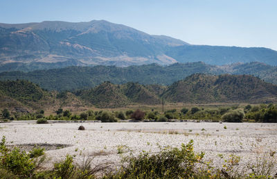 Scenic view of landscape and mountains against sky