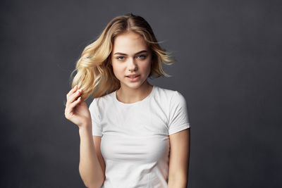 Portrait of a beautiful young woman over black background