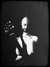 Portrait of man playing guitar