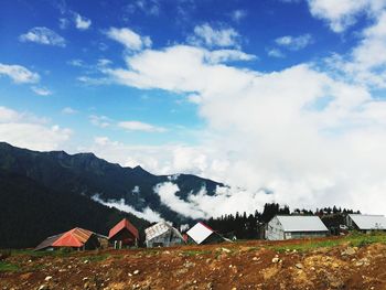 Houses on mountain against sky