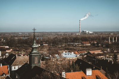 Smoke emitting from chimney against sky