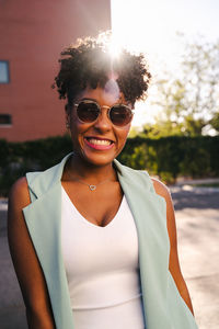Portrait of smiling young woman wearing sunglasses