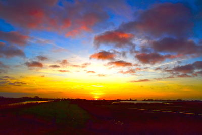 Scenic view of dramatic sky over land