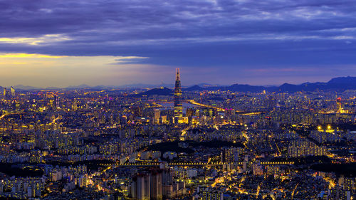 High angle view of city lit up at dusk