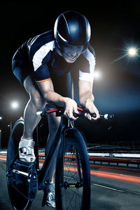 Man riding bicycle at night