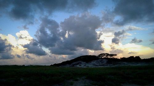 Scenic view of field against sky during sunset