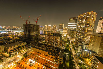 Aerial view of illuminated buildings in city at night