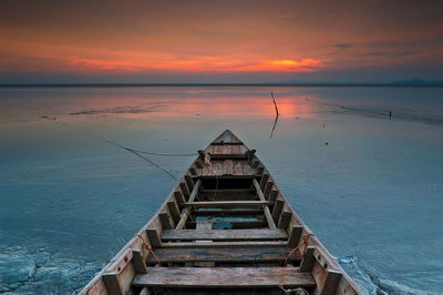 Pier over sea against sky during sunset