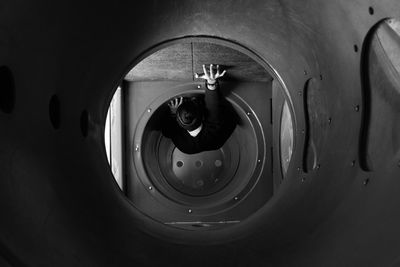 High angle view of person climbing tube