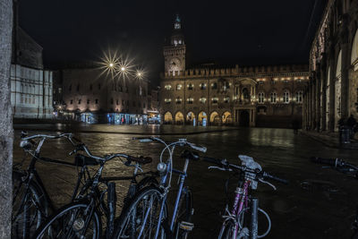 Illuminated buildings by canal at night