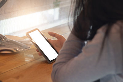 Midsection of man using mobile phone