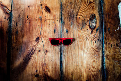 High angle view of sunglasses on wooden table