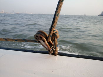 Close-up of metal structure in sea against sky