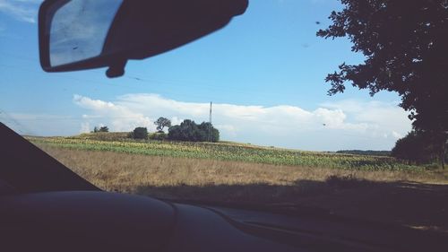 Close-up of car on road against sky