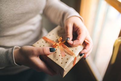 Midsection of woman holding christmas present