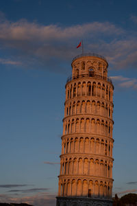 Low angle view of pisa tower against sky with clouds