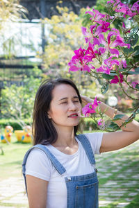 Portrait of beautiful woman with pink flower