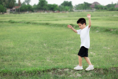 Full length of boy standing on field