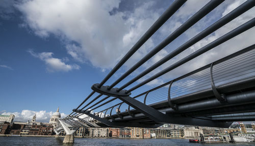 Low angle view of pier over city against sky