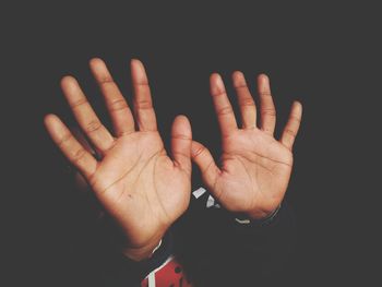 Close-up of man hands over black background