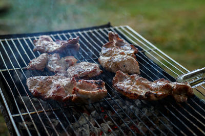 High angle view of meat on barbecue grill