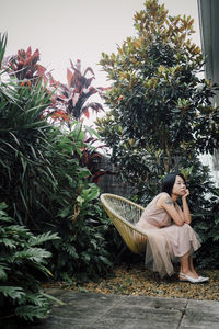 Rear view of woman sitting on hammock