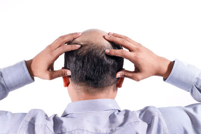 Rear view of man against white background