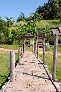 The old bamboo bridge for crossing the paddy field of the countryside village to the local temple.