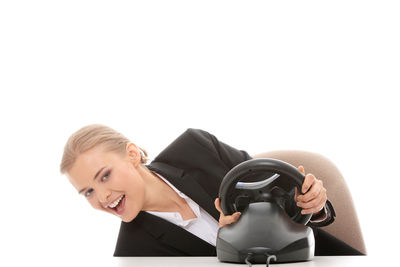 Portrait of smiling young woman against white background