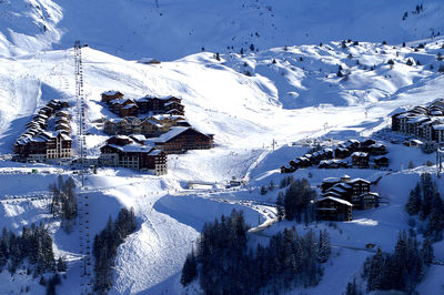 High angle view of snow covered houses and mountains