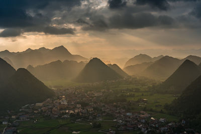 Scenic view of town against cloudy sky